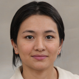 Joyful asian young-adult female with medium  brown hair and brown eyes