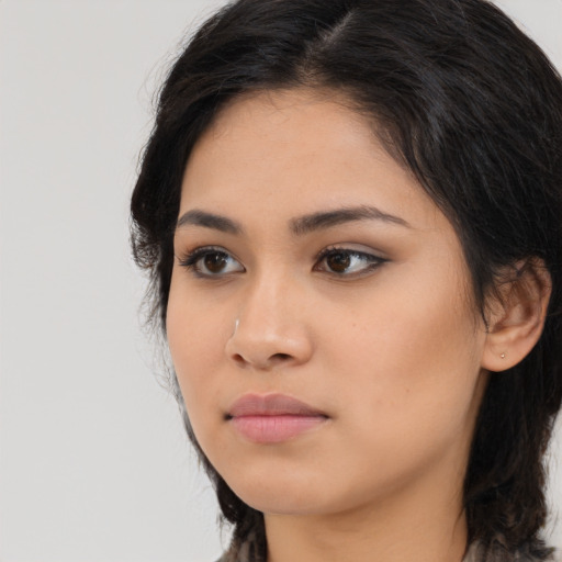 Neutral latino young-adult female with long  black hair and brown eyes