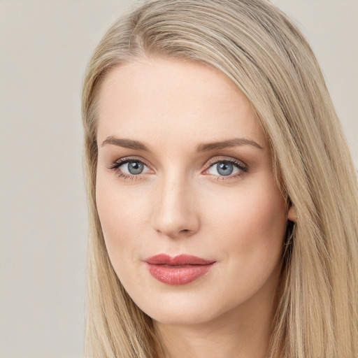 Joyful white young-adult female with long  brown hair and blue eyes