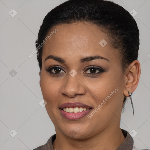 Joyful black young-adult female with short  black hair and brown eyes