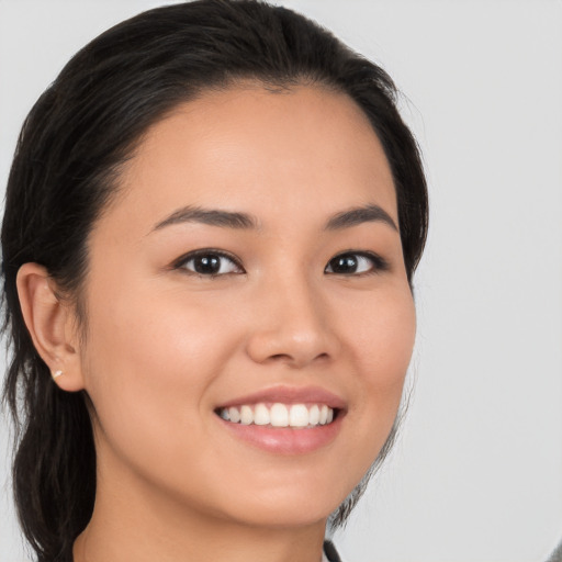 Joyful white young-adult female with medium  brown hair and brown eyes