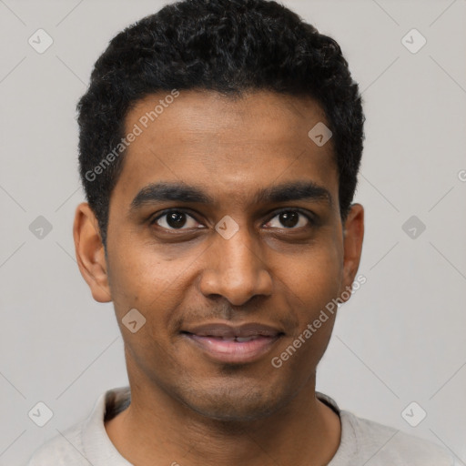 Joyful black young-adult male with short  black hair and brown eyes