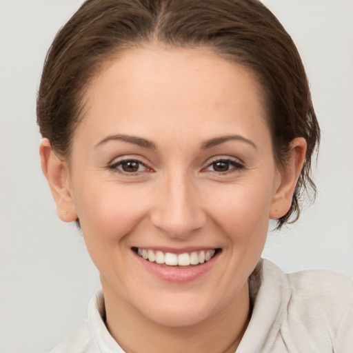 Joyful white young-adult female with medium  brown hair and brown eyes