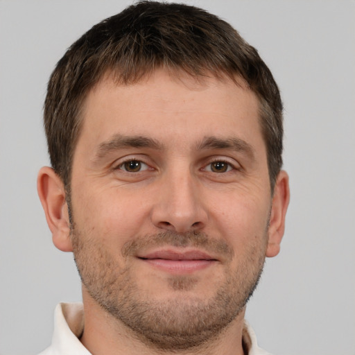 Joyful white young-adult male with short  brown hair and brown eyes