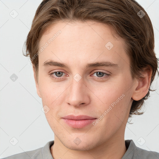 Joyful white young-adult female with short  brown hair and grey eyes