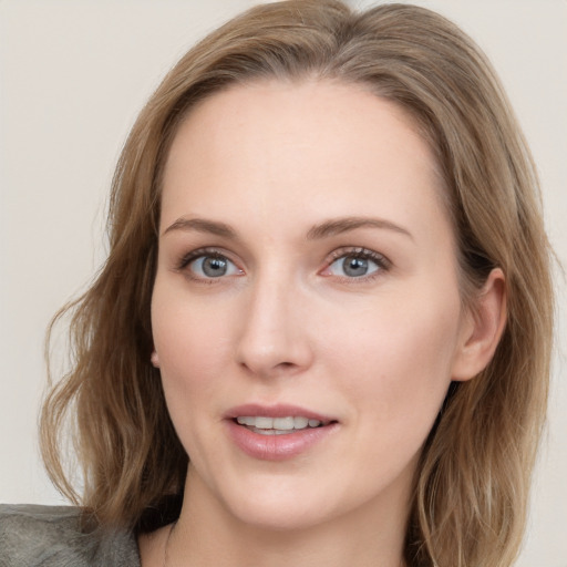 Joyful white young-adult female with long  brown hair and blue eyes