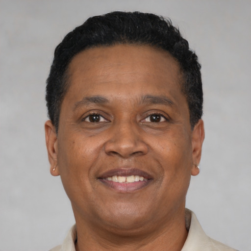 Joyful latino adult male with short  brown hair and brown eyes