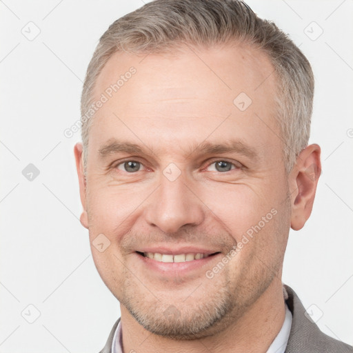 Joyful white adult male with short  brown hair and grey eyes