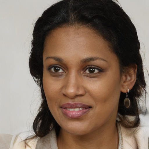 Joyful black young-adult female with medium  brown hair and brown eyes