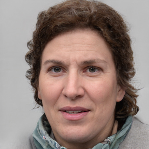 Joyful white adult female with medium  brown hair and blue eyes