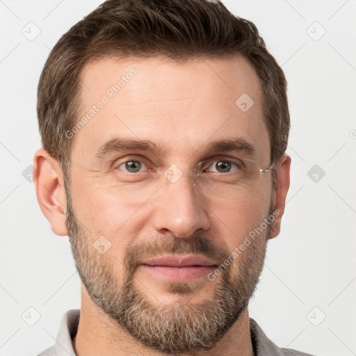 Joyful white adult male with short  brown hair and grey eyes