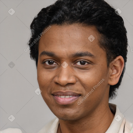 Joyful black young-adult male with short  black hair and brown eyes