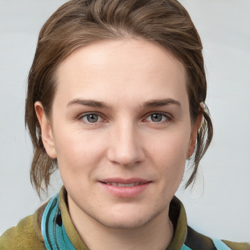 Joyful white young-adult female with medium  brown hair and grey eyes