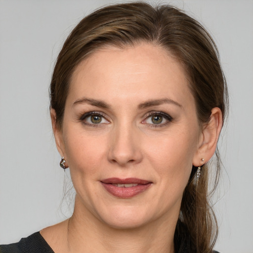 Joyful white young-adult female with medium  brown hair and grey eyes