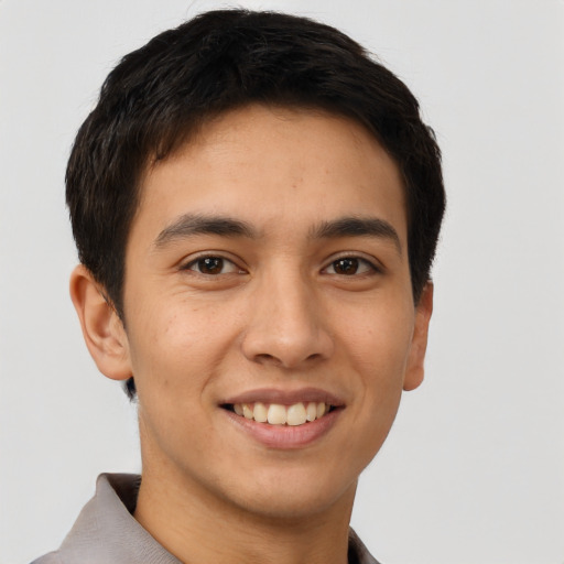 Joyful latino young-adult male with short  brown hair and brown eyes