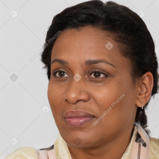 Joyful black adult female with short  brown hair and brown eyes