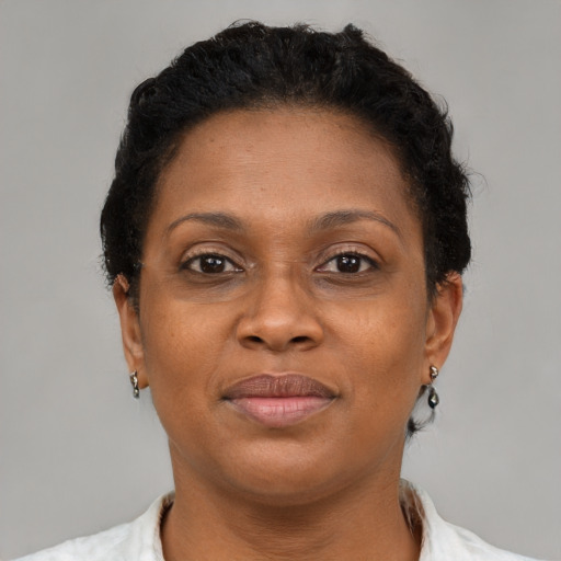 Joyful black adult female with short  brown hair and brown eyes