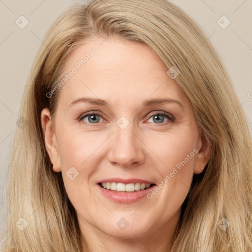 Joyful white adult female with long  brown hair and brown eyes