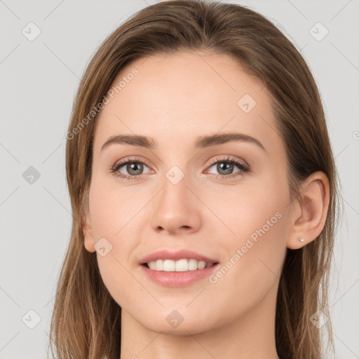 Joyful white young-adult female with long  brown hair and grey eyes