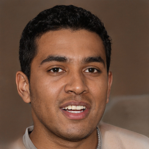 Joyful black young-adult male with short  black hair and brown eyes