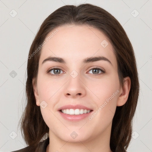 Joyful white young-adult female with long  brown hair and brown eyes