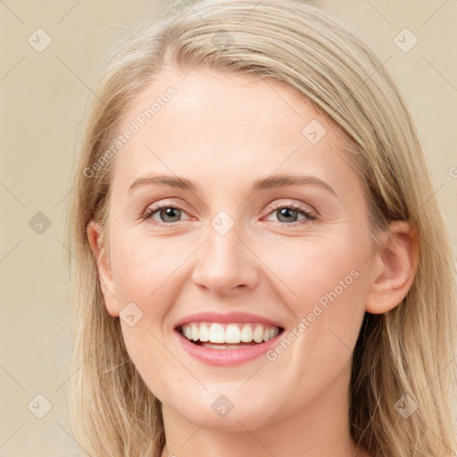 Joyful white young-adult female with long  brown hair and blue eyes