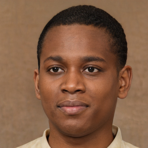 Joyful black young-adult male with short  brown hair and brown eyes
