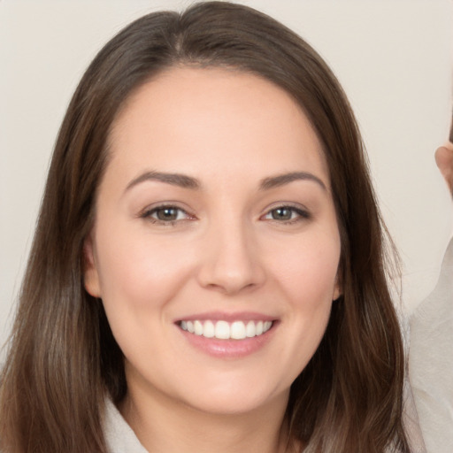 Joyful white young-adult female with long  brown hair and brown eyes