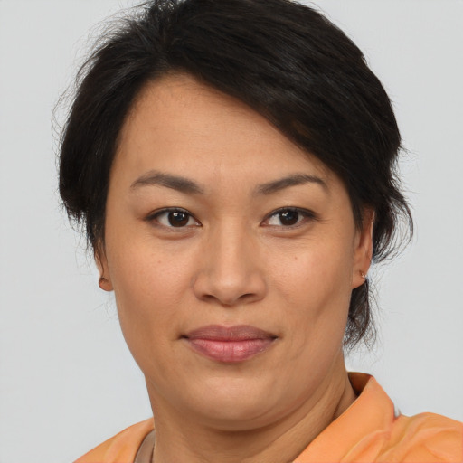Joyful asian young-adult female with short  brown hair and brown eyes