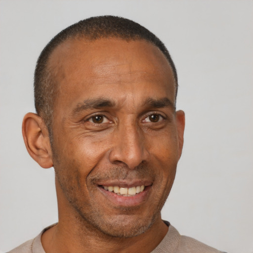 Joyful black adult male with short  black hair and brown eyes