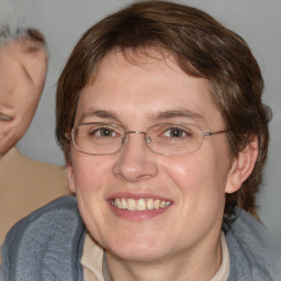 Joyful white adult female with medium  brown hair and blue eyes