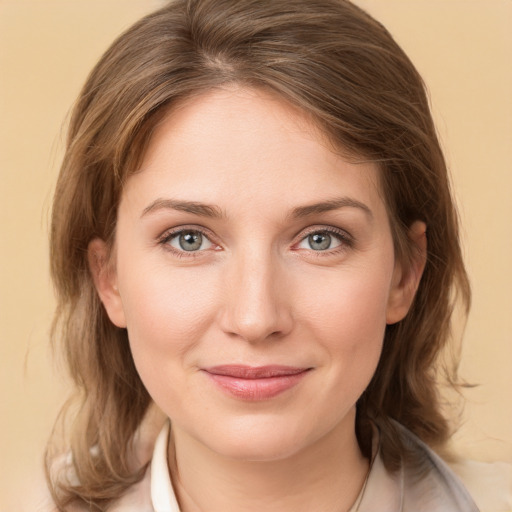 Joyful white young-adult female with medium  brown hair and green eyes