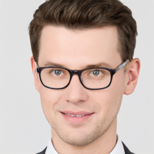 Joyful white adult male with short  brown hair and grey eyes