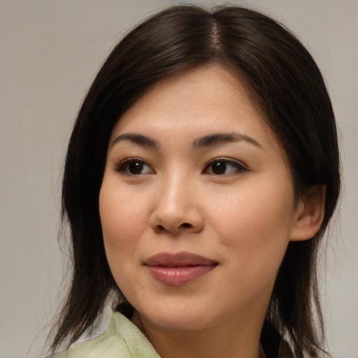 Joyful asian young-adult female with medium  brown hair and brown eyes