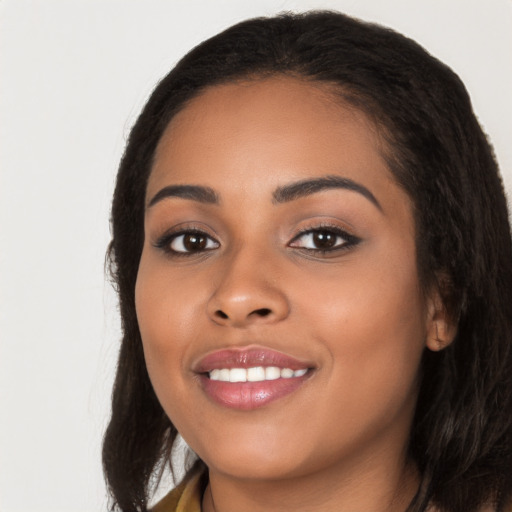 Joyful latino young-adult female with long  black hair and brown eyes