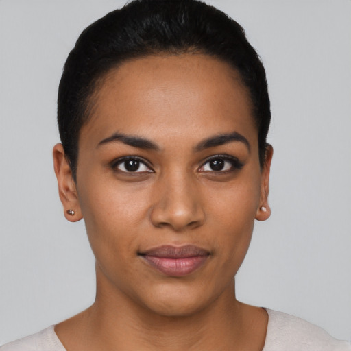 Joyful latino young-adult female with short  black hair and brown eyes