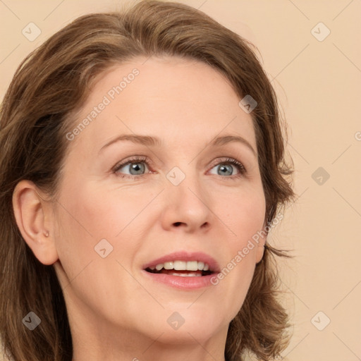 Joyful white adult female with medium  brown hair and green eyes