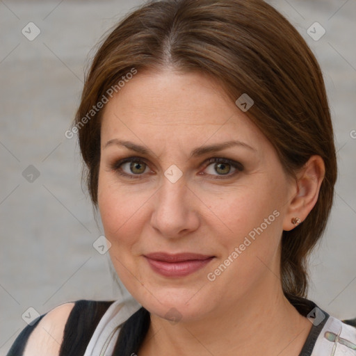 Joyful white adult female with medium  brown hair and blue eyes