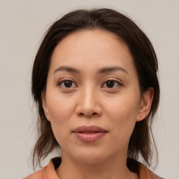 Joyful white young-adult female with medium  brown hair and brown eyes