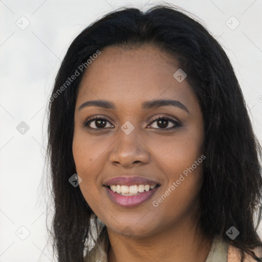 Joyful black young-adult female with long  brown hair and brown eyes