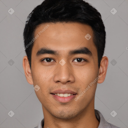 Joyful latino young-adult male with short  black hair and brown eyes