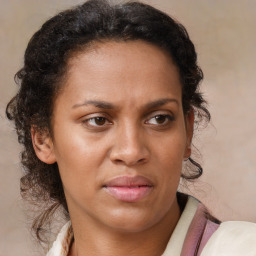 Joyful black adult female with medium  brown hair and brown eyes