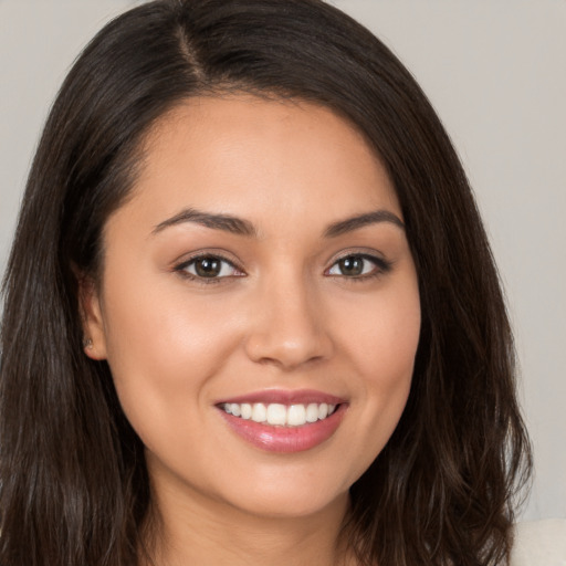 Joyful white young-adult female with long  brown hair and brown eyes