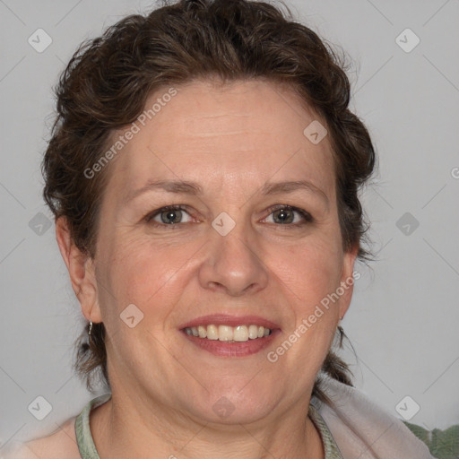 Joyful white adult female with medium  brown hair and blue eyes