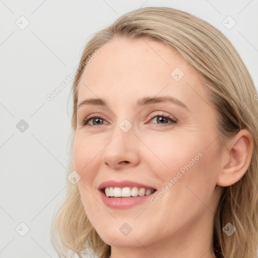 Joyful white young-adult female with long  brown hair and blue eyes