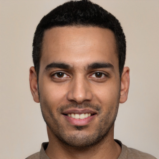 Joyful latino young-adult male with short  black hair and brown eyes
