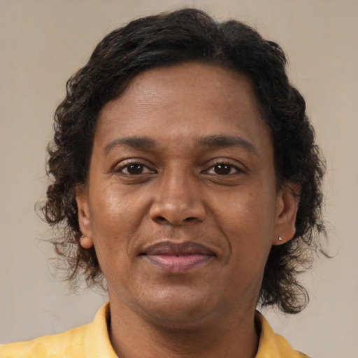 Joyful latino adult female with short  brown hair and brown eyes