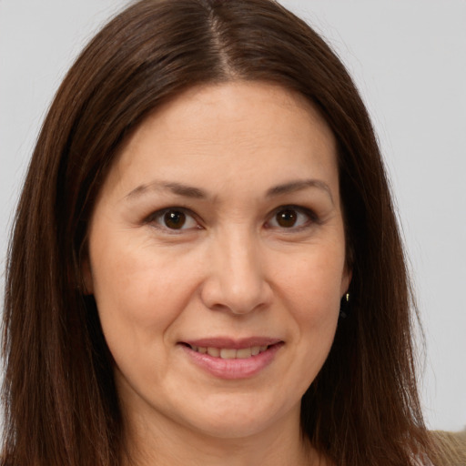 Joyful white adult female with long  brown hair and brown eyes