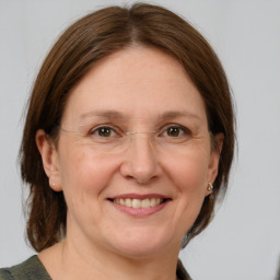 Joyful white adult female with medium  brown hair and grey eyes