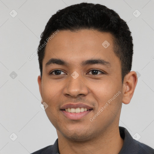 Joyful latino young-adult male with short  black hair and brown eyes